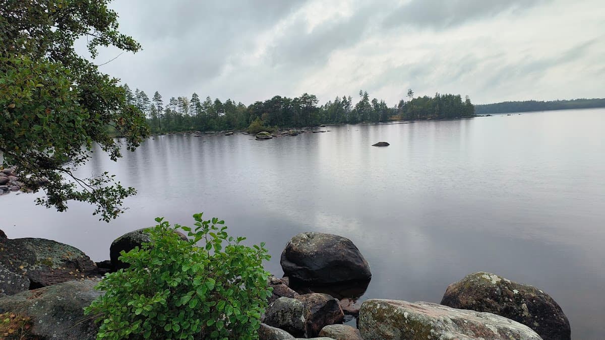 Vy över rastplats Innaren vid sjön Innaren längs väg 31 med sjöutsikt och picknickbord.