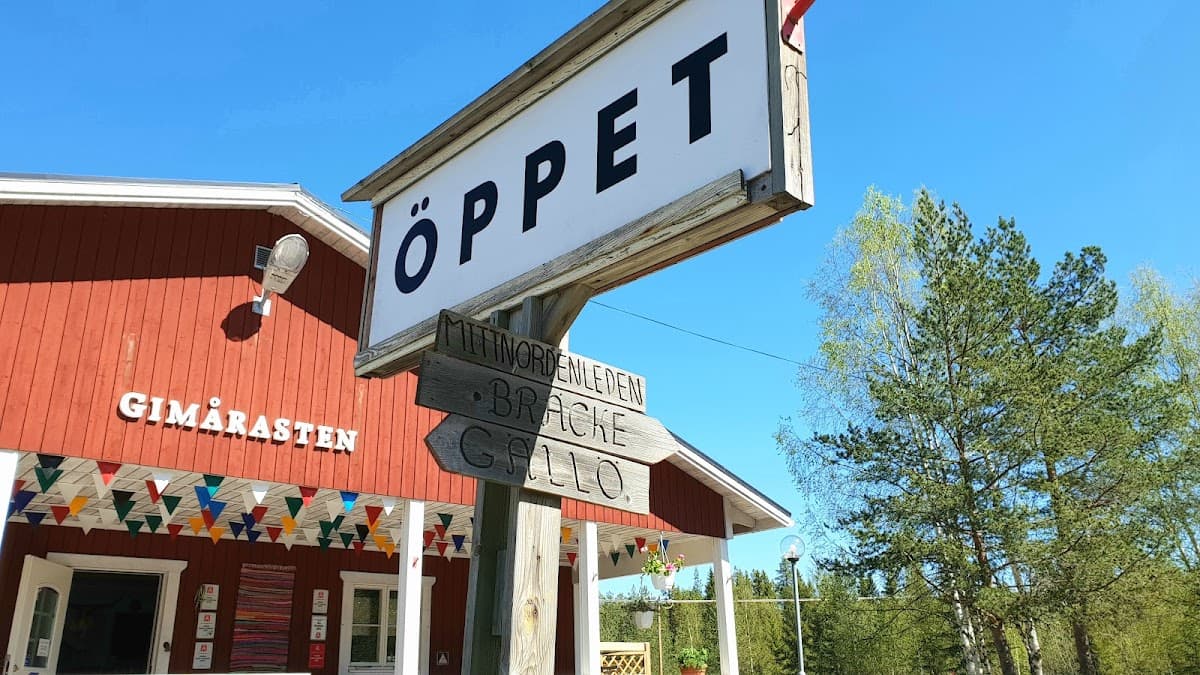 Rastplats Gimån vid väg 321 i Jämtland med tallskog, lekplats och sittplatser nära vattnet.